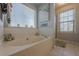 Relaxing bathroom with a soaking tub, separate shower, and large window at 557 Bradford Park, Loganville, GA 30052