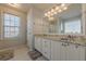 Bright bathroom featuring double vanity, granite countertops, and modern fixtures at 557 Bradford Park, Loganville, GA 30052