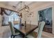 Dining room with a large window and designer light fixture at 557 Bradford Park, Loganville, GA 30052