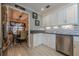 Stylish kitchen boasting stainless steel appliances, white cabinets, and eye-catching backsplash at 557 Bradford Park, Loganville, GA 30052