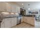 Updated kitchen featuring granite counters, white cabinets, stainless appliances and tile backsplash at 557 Bradford Park, Loganville, GA 30052