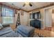 Comfortable living room with large TV, ceiling fan, and bookshelf wallpaper border at 557 Bradford Park, Loganville, GA 30052