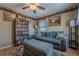 Comfortable living room features a bookshelf, ceiling fan, and a couch with an ottoman at 557 Bradford Park, Loganville, GA 30052