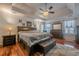 Serene main bedroom with tray ceilings, hardwood floors, and elegant decor at 557 Bradford Park, Loganville, GA 30052