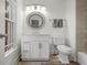 Well-lit bathroom with granite countertop, decorative mirror, and modern fixtures at 610 Timm Valley Ne Rd # B, Atlanta, GA 30305