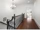 Upstairs hallway featuring hardwood floors, decorative railing, and natural lighting at 610 Timm Valley Ne Rd # B, Atlanta, GA 30305