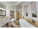 This is a soaking tub in the luxurious main bathroom, with a walk-in shower and vanity at 610 Timm Valley Ne Rd # B, Atlanta, GA 30305