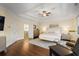 This spacious main bedroom is illuminated by natural light and features a tray ceiling and wooden floors at 610 Timm Valley Ne Rd # B, Atlanta, GA 30305