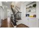 Beautiful staircase with dark wood floors, white trim, and a built-in bookcase at 610 Timm Valley Ne Rd # B, Atlanta, GA 30305