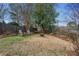 Spacious backyard featuring a fire pit, mature trees, a fence, and two Adirondack chairs at 2120 Mckinley Nw Rd, Atlanta, GA 30318