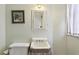 This bathroom features a vintage sink and toilet, complemented by a framed artwork at 2120 Mckinley Nw Rd, Atlanta, GA 30318