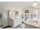 Bathroom featuring double sinks, large mirrors, and bright natural light from the windows at 2120 Mckinley Nw Rd, Atlanta, GA 30318