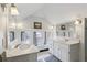 Bathroom featuring double sinks, large mirrors, and bright natural light from the windows at 2120 Mckinley Nw Rd, Atlanta, GA 30318