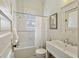 Bathroom with an updated sink, white tiles and a shower/tub combo at 2120 Mckinley Nw Rd, Atlanta, GA 30318