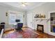 Bedroom featuring a decorative fireplace, hardwood floors, and ample natural light at 2120 Mckinley Nw Rd, Atlanta, GA 30318