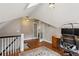 Bonus room with hardwood floors, a skylight, and a workspace setup near the staircase at 2120 Mckinley Nw Rd, Atlanta, GA 30318