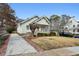 Charming home with a well-manicured lawn, a covered porch, and a driveway at 2120 Mckinley Nw Rd, Atlanta, GA 30318