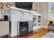 Close-up of the living room fireplace with white painted brick and built-in shelving at 2120 Mckinley Nw Rd, Atlanta, GA 30318