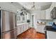 Updated kitchen with stainless steel appliances, white cabinetry, and terra cotta tile flooring at 2120 Mckinley Nw Rd, Atlanta, GA 30318