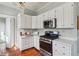 Kitchen featuring stainless steel appliances, white cabinets, and an oven at 2120 Mckinley Nw Rd, Atlanta, GA 30318