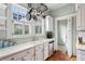 Kitchen with custom cabinets, white countertops, and stainless steel dishwasher at 2120 Mckinley Nw Rd, Atlanta, GA 30318