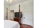 Traditional style main bedroom with a four poster bed, wood floors, and a TV on the dresser at 2120 Mckinley Nw Rd, Atlanta, GA 30318