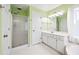 Bright bathroom with a glass shower, white cabinets, and a large mirror at 3524 Pine Grove Drive, Douglasville, GA 30135