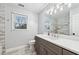 Renovated bathroom with grey vanity, granite countertop, and tiled shower at 3524 Pine Grove Drive, Douglasville, GA 30135