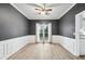 Dining room featuring paneled walls, a ceiling fan, and light hardwood floors at 3524 Pine Grove Drive, Douglasville, GA 30135