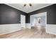 Dining room with white wainscoting, gray walls, and light hardwood floors at 3524 Pine Grove Drive, Douglasville, GA 30135