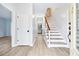 Bright entryway features hardwood floors and a staircase with wood and iron railing at 3524 Pine Grove Drive, Douglasville, GA 30135