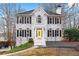 Charming two-story brick home with black shutters and a welcoming yellow front door at 3524 Pine Grove Drive, Douglasville, GA 30135