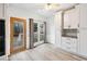 Bright kitchen nook with white cabinets, modern appliances, and a door leading to an outdoor deck at 3524 Pine Grove Drive, Douglasville, GA 30135