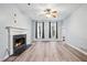 Cozy living room with hardwood floors, a fireplace, and natural light from large windows at 3524 Pine Grove Drive, Douglasville, GA 30135