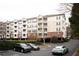 Apartment building featuring a landscaped parking area and access to garage parking below the building at 4333 Dunwoody Park # 2104, Dunwoody, GA 30338