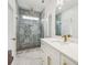 Bathroom featuring marble floors, a shower and white cabinets at 4566 Town Manor Dr, Douglasville, GA 30135