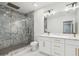 Modern bathroom featuring a glass shower, elegant gray tile, double vanity, marble counters, and gold fixtures at 4566 Town Manor Dr, Douglasville, GA 30135