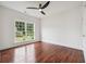 Bright bedroom featuring hardwood floors, a large window with a view, and white walls at 4566 Town Manor Dr, Douglasville, GA 30135