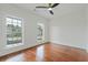 A cozy bedroom featuring hardwood floors, a ceiling fan, and sunlit windows at 4566 Town Manor Dr, Douglasville, GA 30135