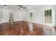 Spacious bedroom featuring hardwood floors, a ceiling fan, and bright windows at 4566 Town Manor Dr, Douglasville, GA 30135