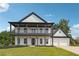 Stunning two-story home featuring a double stacked porch, black trim, white siding, and a manicured front lawn at 4566 Town Manor Dr, Douglasville, GA 30135