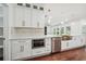 Well-lit kitchen featuring stainless appliances, custom cabinetry with gold hardware, and an undermount sink at 4566 Town Manor Dr, Douglasville, GA 30135