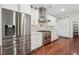 Gourmet kitchen featuring stainless appliances, white cabinets with gold hardware, and tile backsplash at 4566 Town Manor Dr, Douglasville, GA 30135