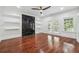 Spacious living room with hardwood floors, a black marble fireplace, and ample natural light from the French doors at 4566 Town Manor Dr, Douglasville, GA 30135