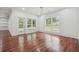 Living room featuring shiplap walls, hardwood flooring, and lots of natural light from multiple windows at 4566 Town Manor Dr, Douglasville, GA 30135