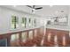 Bright living room with hardwood floors, neutral walls, lots of windows, and an open concept to a kitchen area at 4566 Town Manor Dr, Douglasville, GA 30135