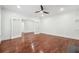 Large living room featuring hardwood floors, white walls, recessed lighting, and a connecting room with glass doors at 4566 Town Manor Dr, Douglasville, GA 30135