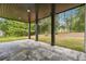 A covered patio featuring gray marble flooring, dark pillars, and a picturesque backyard at 4566 Town Manor Dr, Douglasville, GA 30135