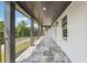 Relaxing covered porch featuring stone tile floors, black metal railing, and substantial support columns at 4566 Town Manor Dr, Douglasville, GA 30135