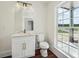 A stylish powder room featuring a marble vanity, gold hardware, and wood-look flooring at 4566 Town Manor Dr, Douglasville, GA 30135